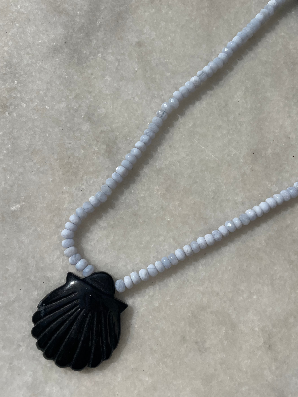 Close-up of black onyx and chalcedony necklace with black pendant
