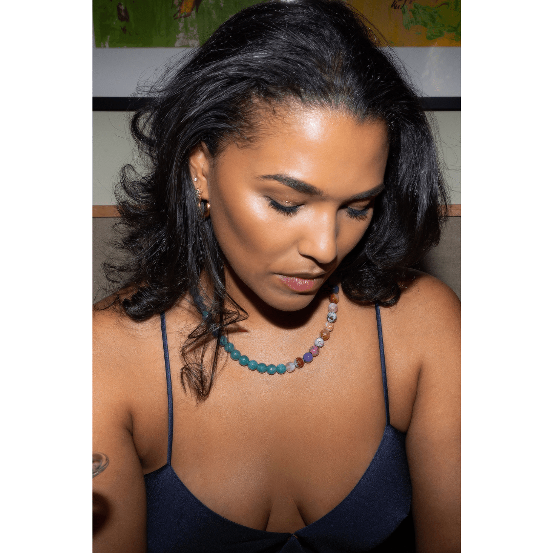 Woman wearing clear petrol quartz and pink fire agate necklace