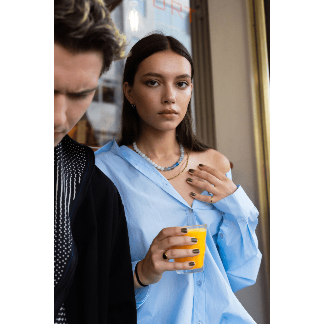 Woman wearing blue jade and blue quartz necklace