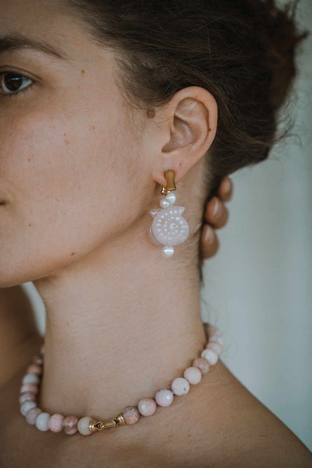 Woman wearing pearl hoop earrings