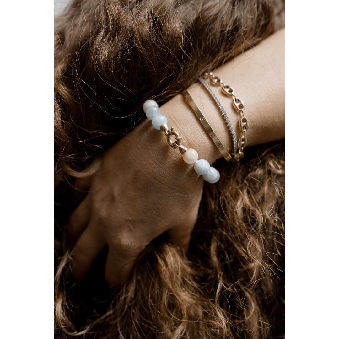 Woman wearing aquamarine bracelet minimal jewelry